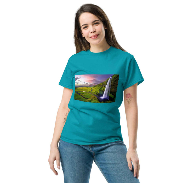 Woman wearing teal tee with golden sunset waterfall print